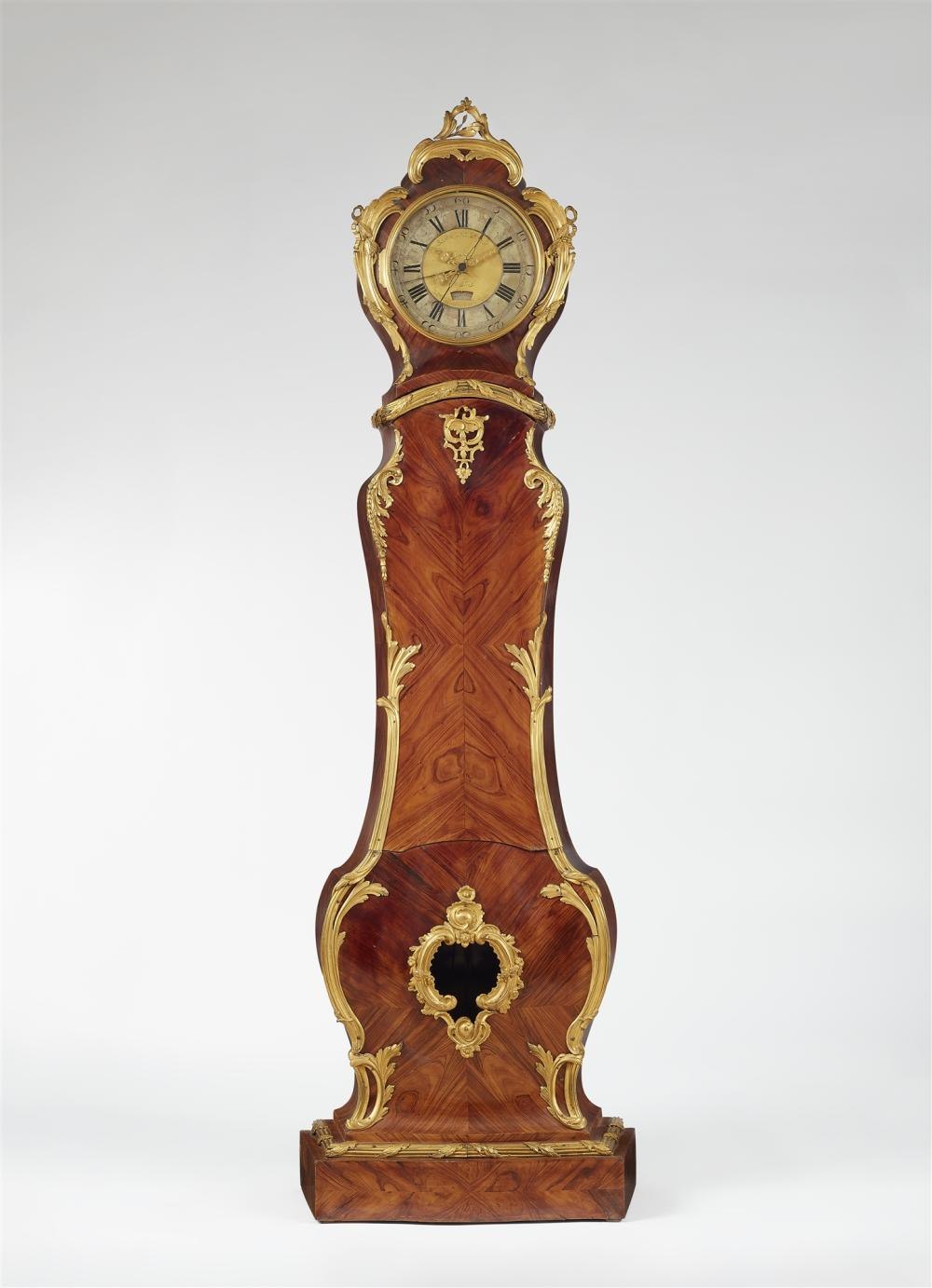 Front view of the regulator clock, showing the wood-veneered case and dial.