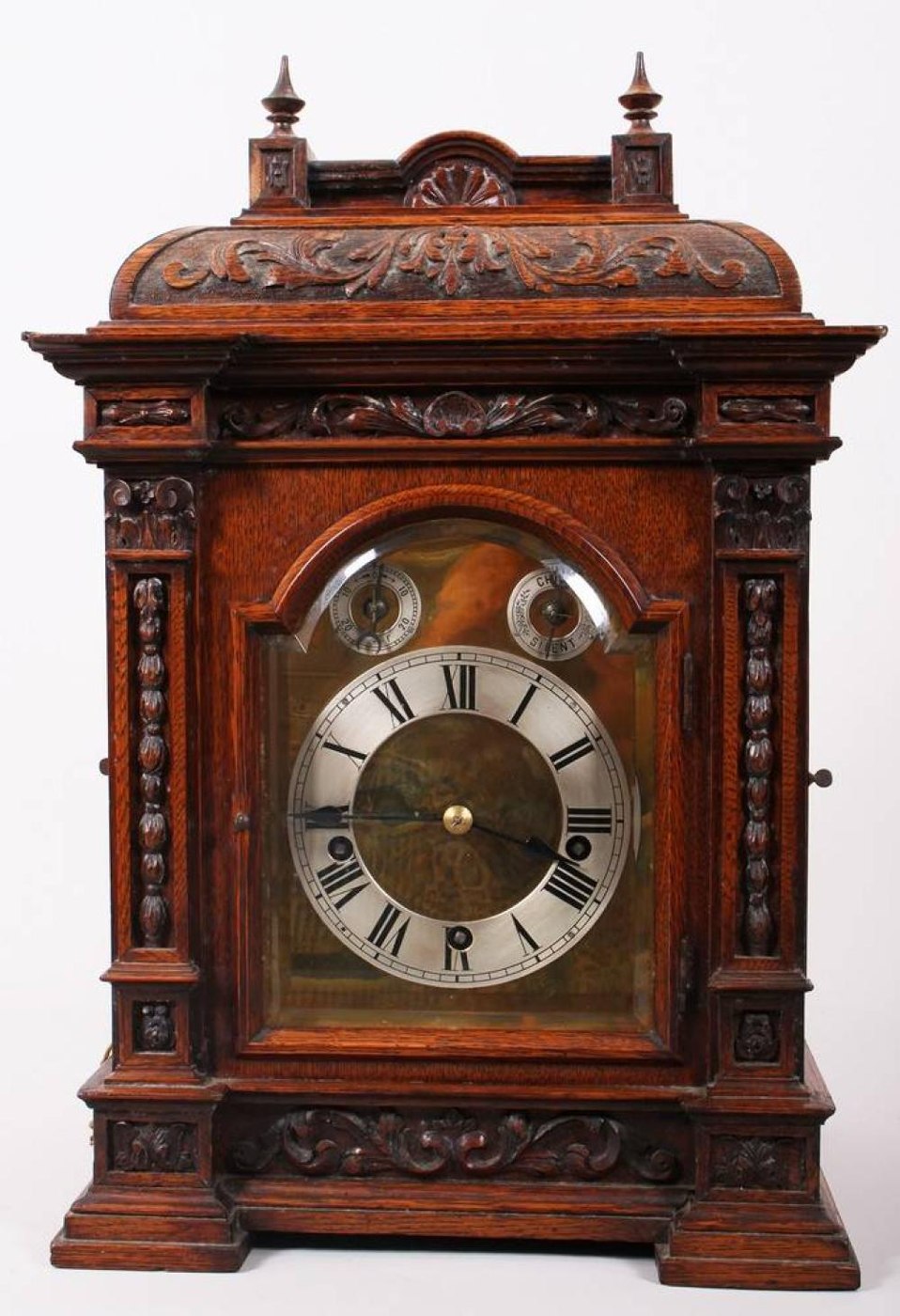 Front view of the Reinhold Schnekenburger bracket clock, highlighting the dial and decorative wooden case.