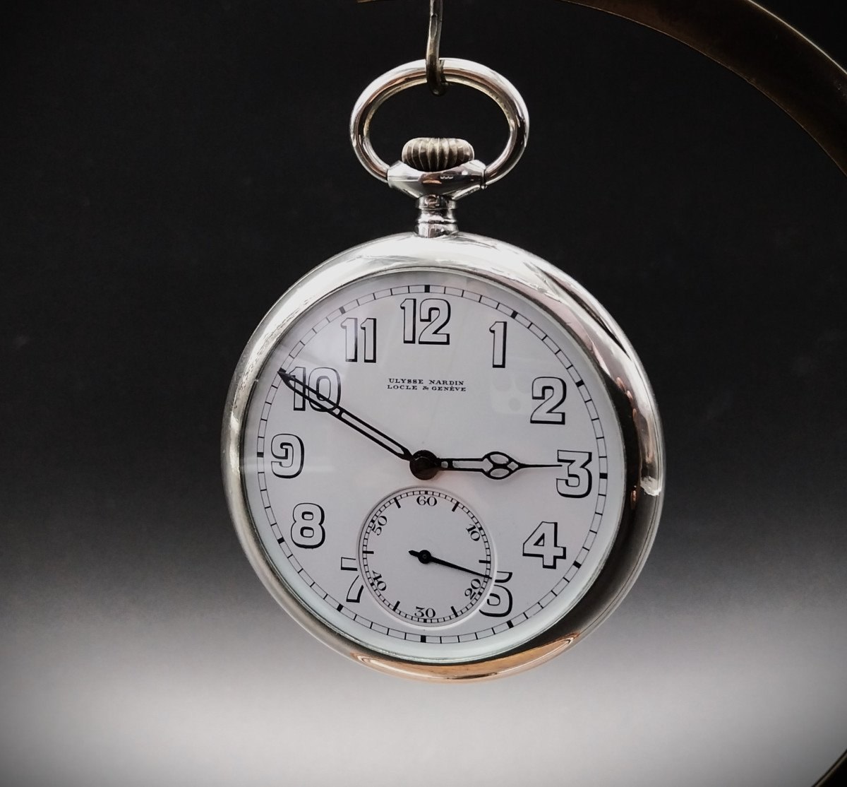 Front view of the Ulysse Nardin Corps of Engineers pocket watch suspended on a stand