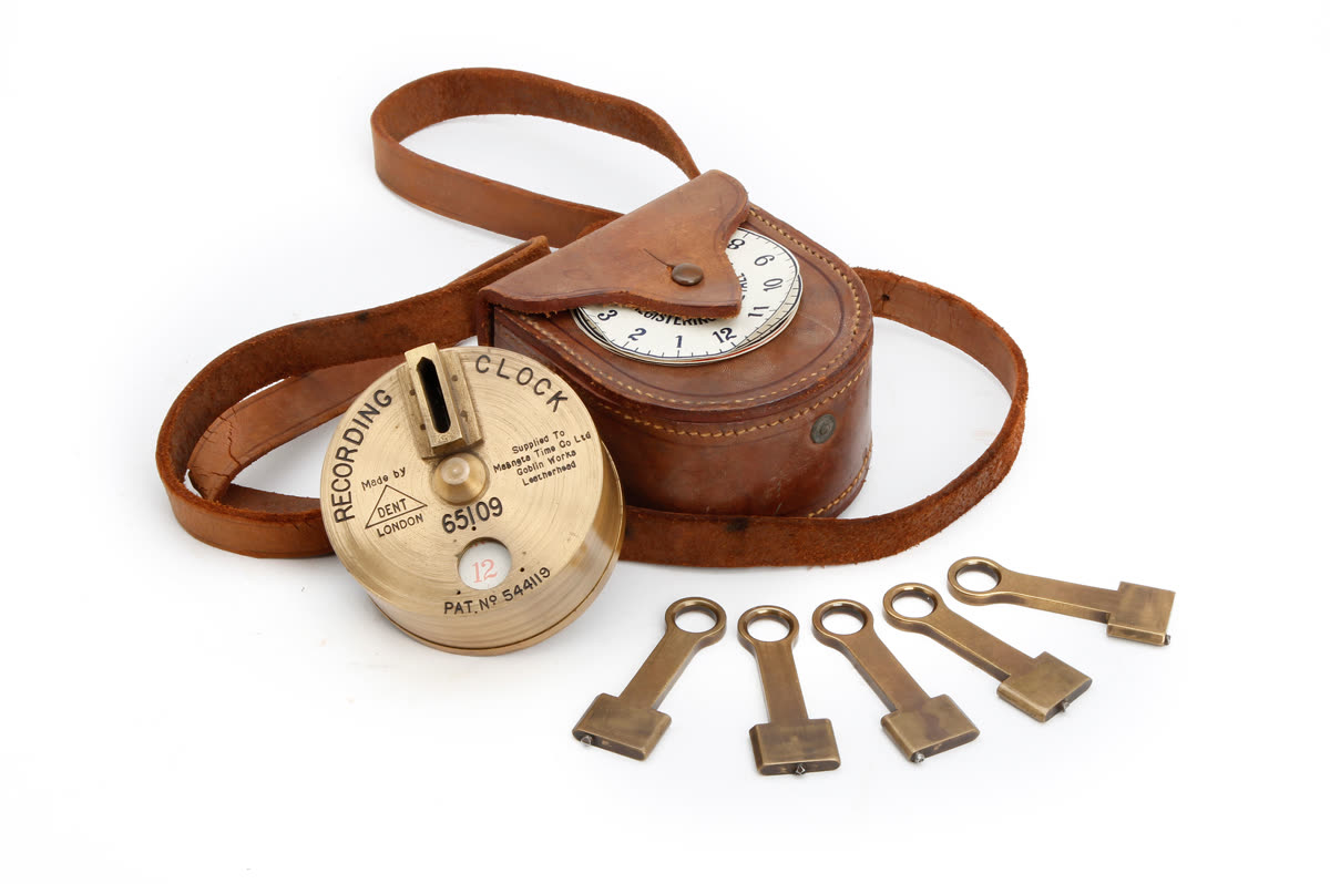Dent night watchman's brass recording clock shown with leather carrying case and five brass station keys