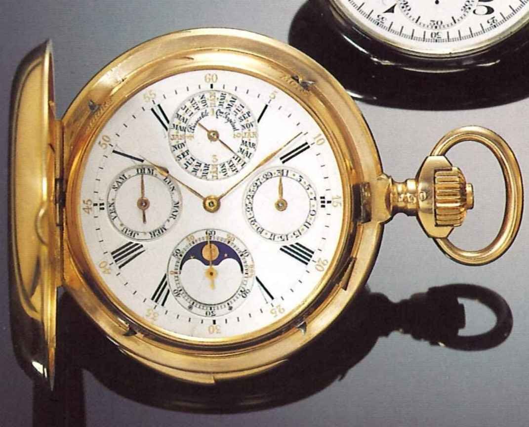 The obverse of the 18 ct. pink gold hunting cased pocket watch with open cover showing the enamel dial and astronomical indicators.