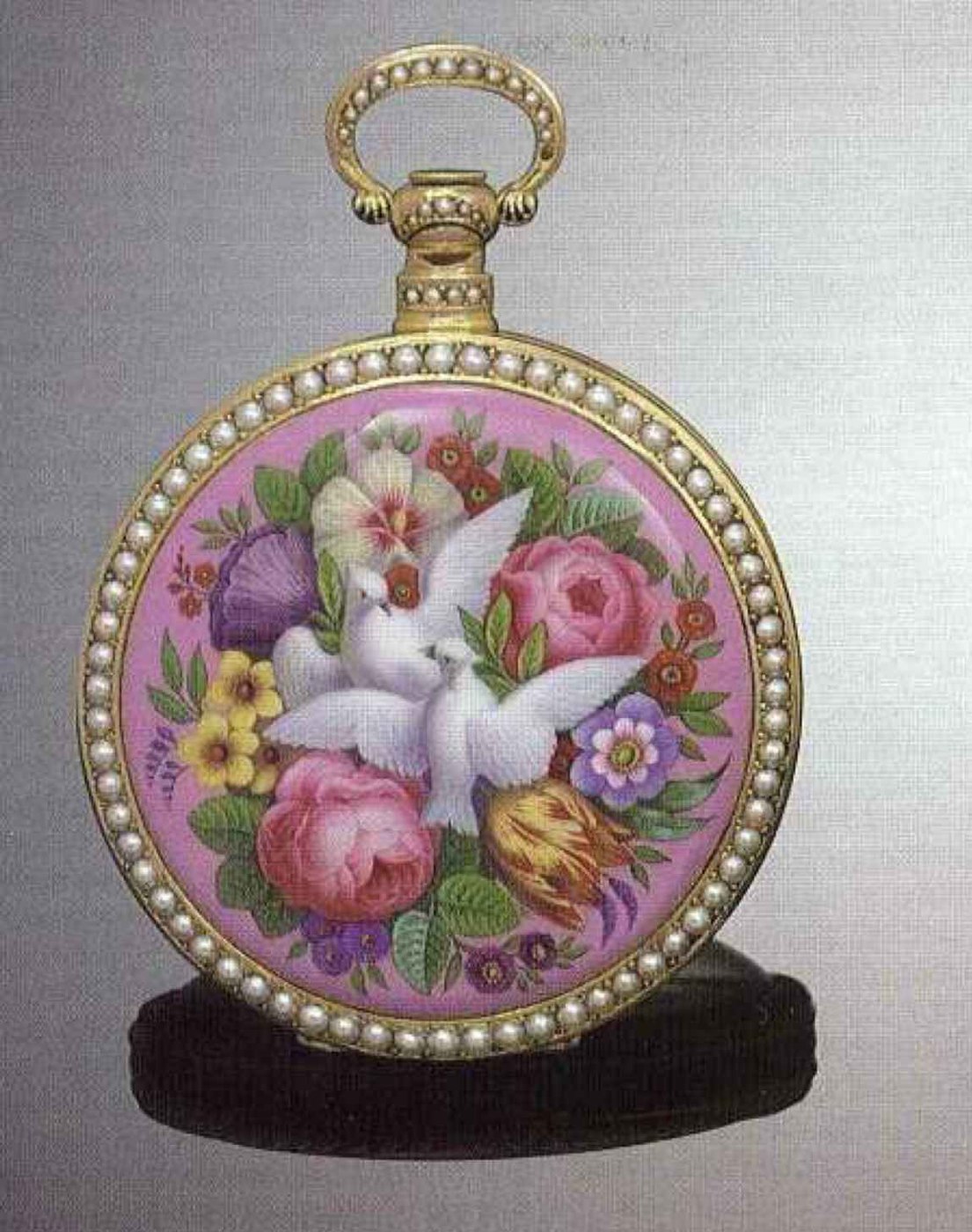Rear view showing the enamel panel with doves and floral composition surrounded by split pearls.