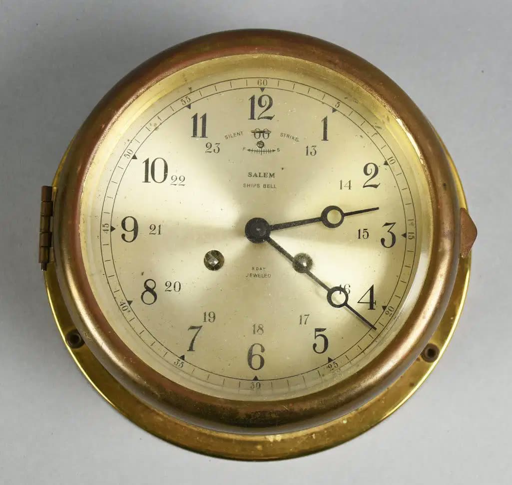 Front view of Salem Ships Bell 8-day maritime clock in brass case