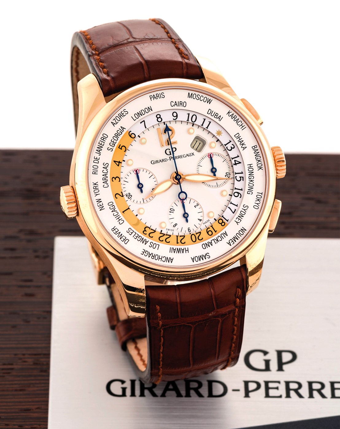 Front view of the Girard-Perregaux World Time Chronograph in 18K pink gold with a brown leather strap.