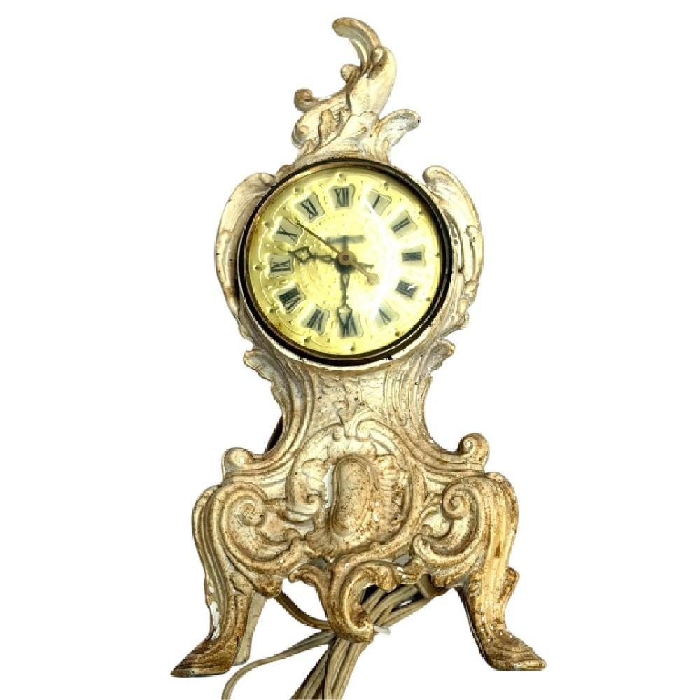 View of the vintage Renaissance ornate electric mantel clock showing the dial, decorative scrollwork, and attached power cord.