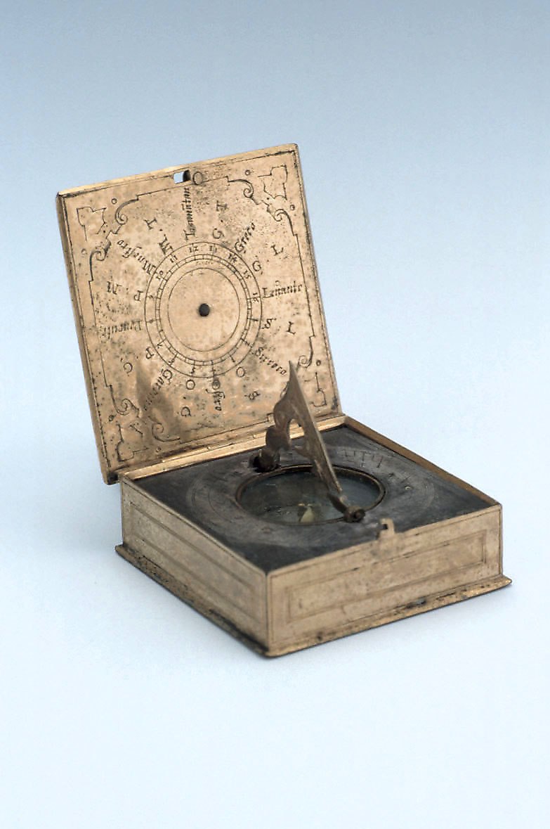 View of the open horizontal dial showing the compass, gnomon, and inner lid wind rose.