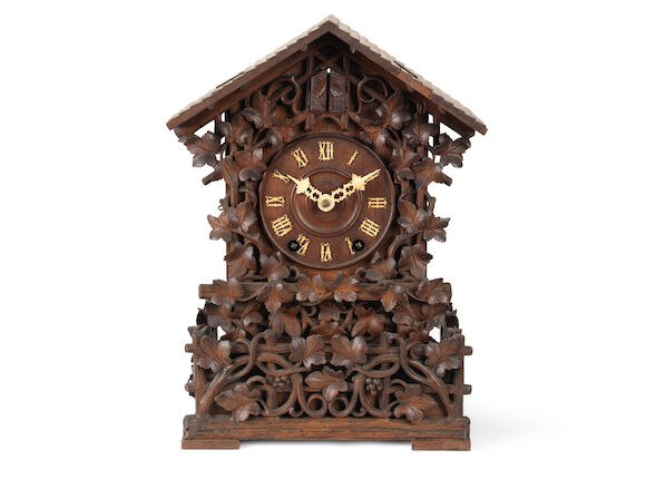 Front view of the chalet-style carved wood Black Forest cuckoo clock