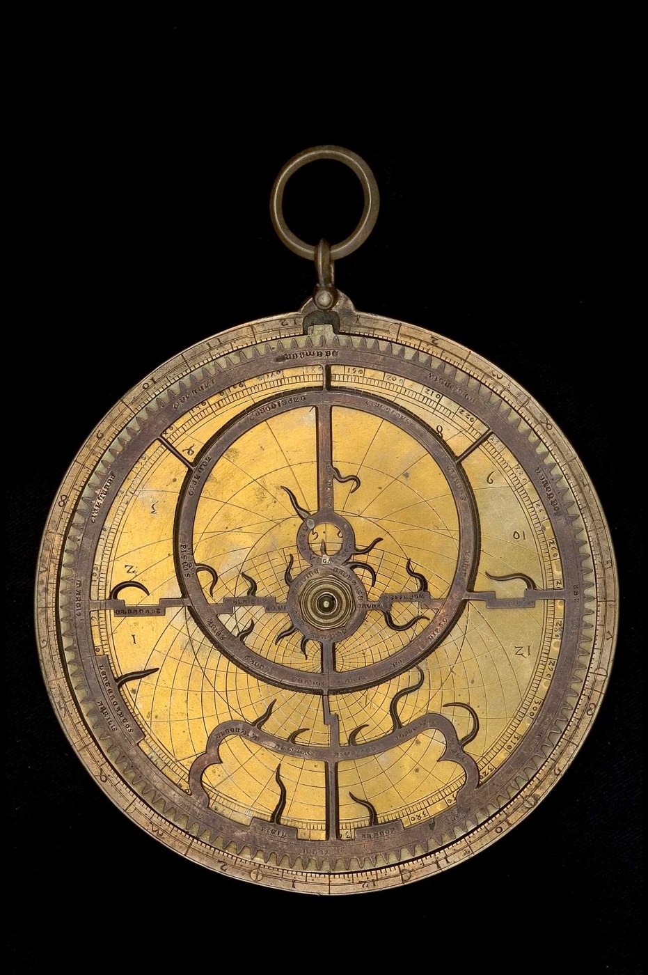 The front face of the astrolabe, displaying the rete with stars and the universal projection plate underneath.