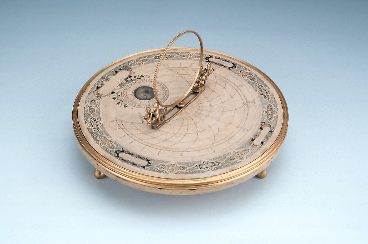 The azimuth dial, showing the circular stone tablet, the central gnomon with rearing horses, and the inset compass.