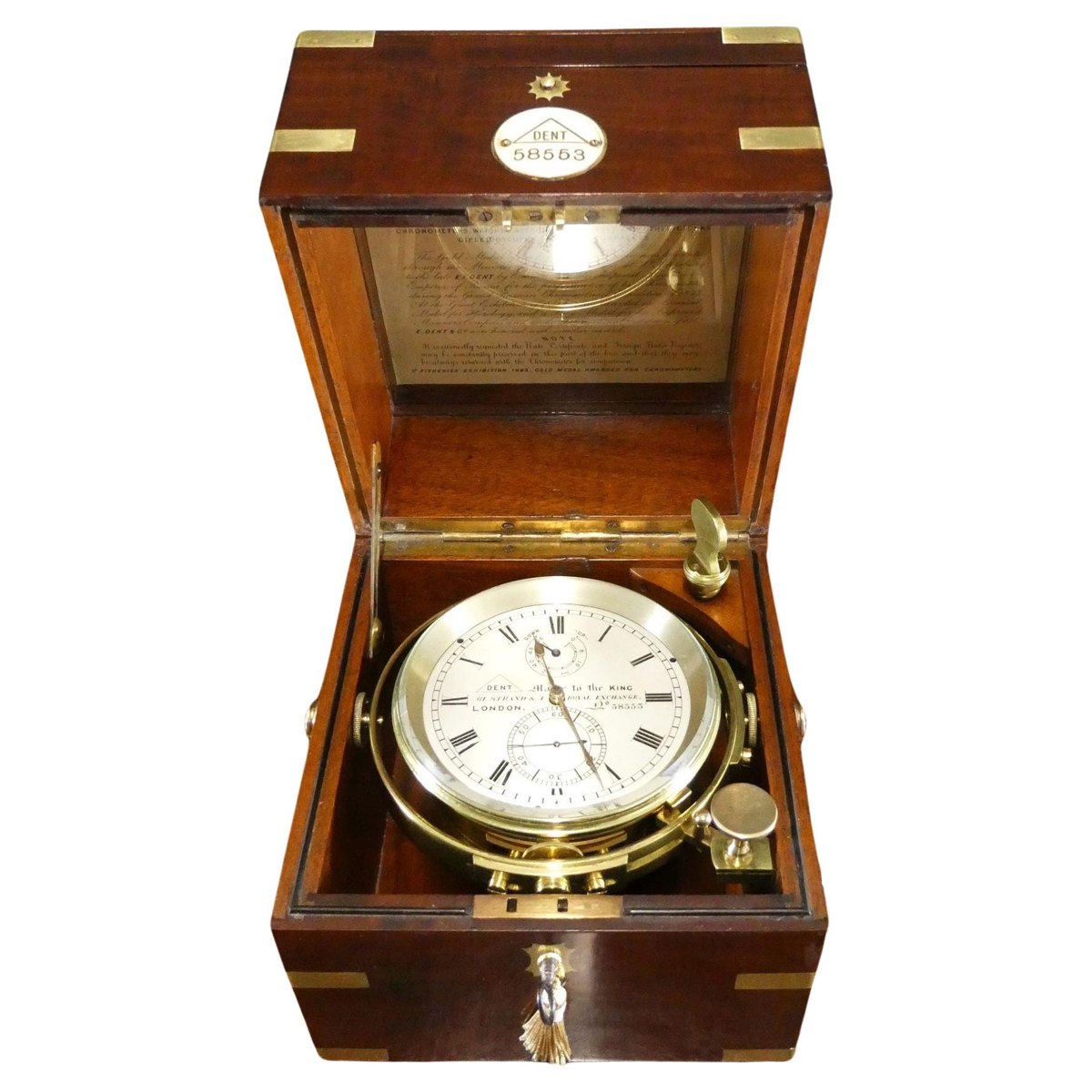 Dent marine chronometer No. 58553 in an open brass-bound mahogany box