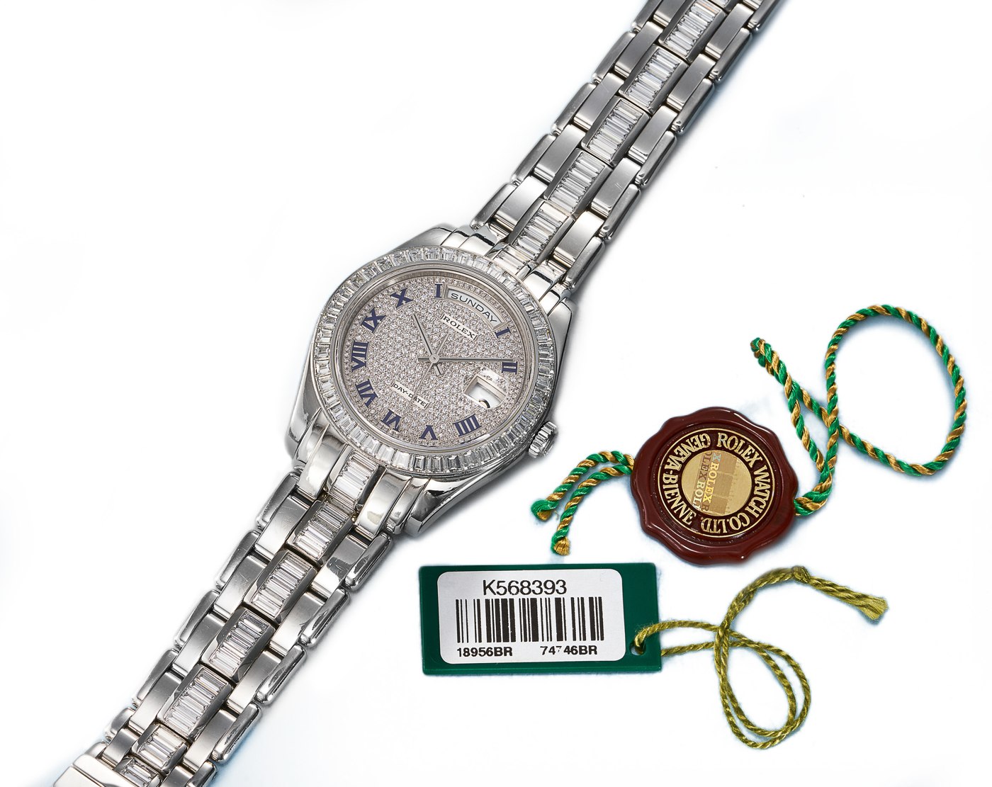 The Rolex Oyster Perpetual Day-Date Ref. 18956 BR, shown with its accompanying tags.