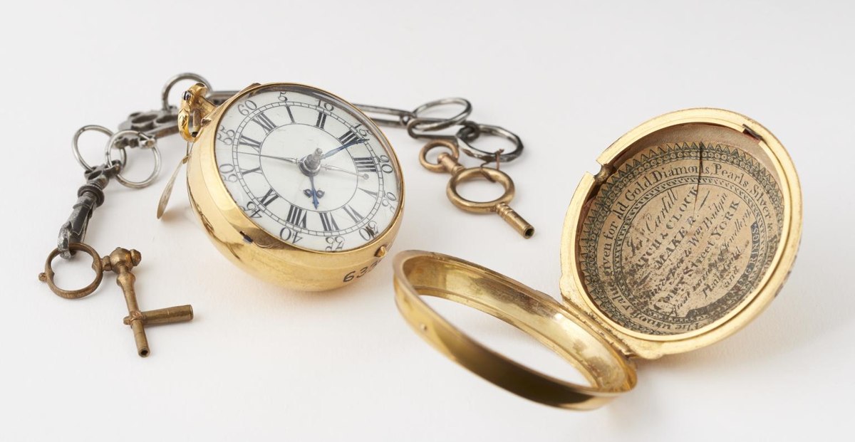 Oblique view of the gold-cased George Graham cylinder stop-watch, showing dial, chain with two keys, and open outer case with printed watch paper