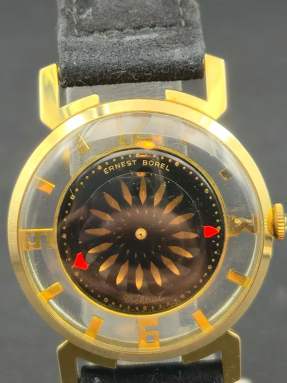 Front view of the Ernest Borel Cocktail wristwatch showing the rotating kaleidoscopic dial and red indicators