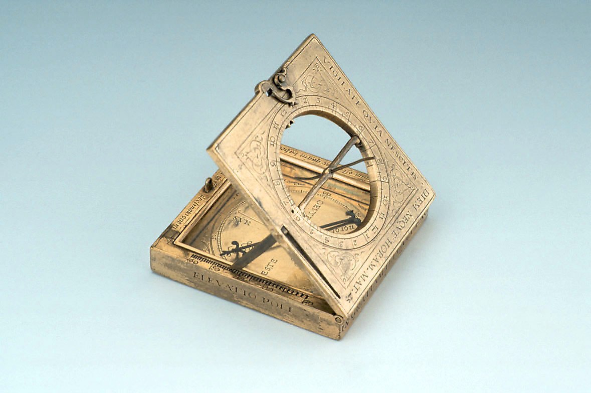 Gilt brass equinoctial dial by Petrus ab Aggere, dated 1562, showing the open lid and internal compass.