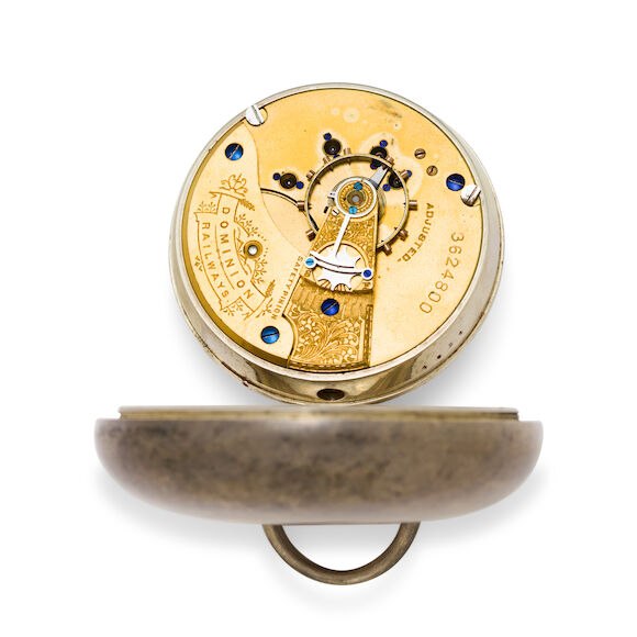 Top-plate view of the Waltham gilt full-plate movement swung out from its silver case