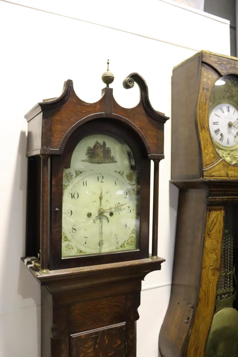 Hood and upper trunk of the longcase clock showing the painted arched dial