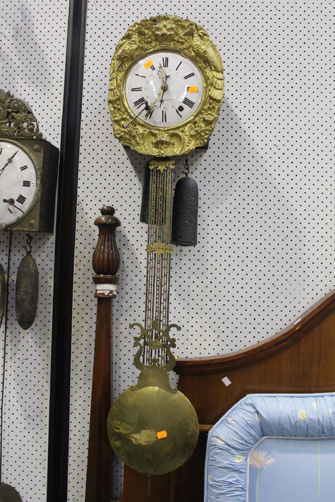 Antique French Comtoise clock movement with repoussé brass surround, gridiron lyre pendulum, and weights