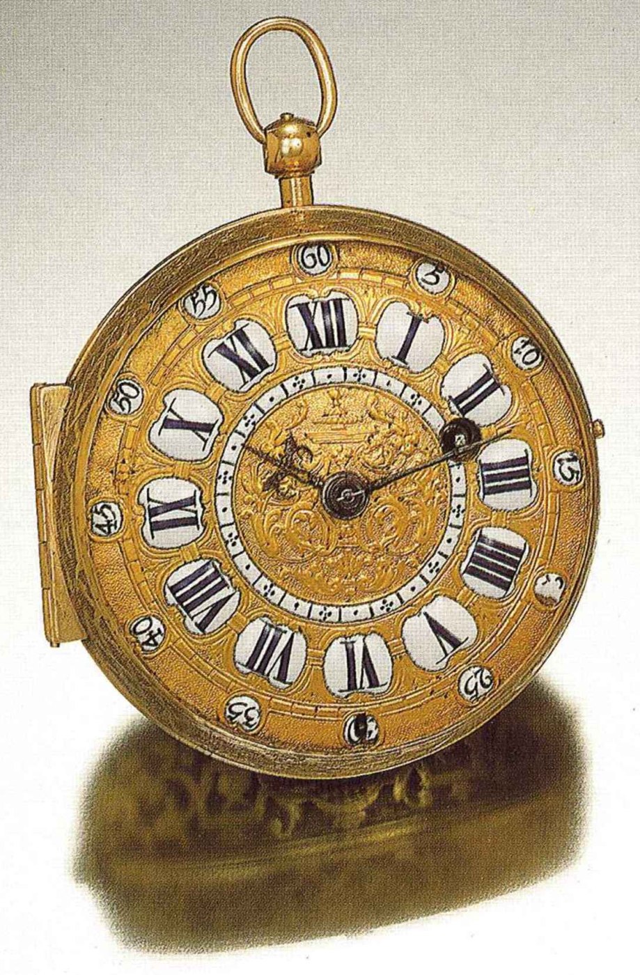 Front view of the gilt brass oignon watch, showing the enamel cartouches and intricate dial engraving.