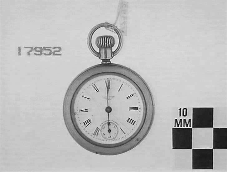 Front view of the Waterbury pocket watch showing the white enamel dial, Roman numerals, and seconds sub-dial.