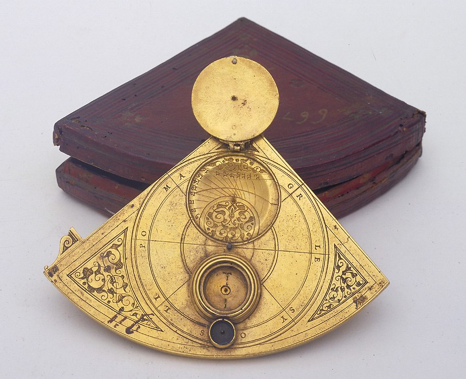 Gilt brass quadrant with open scaphe sundial cover and original case in the background.