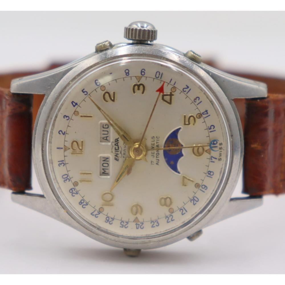Front view of the Enicar Triple Calendar moonphase wristwatch showing the silver dial, calendar apertures, and leather strap.