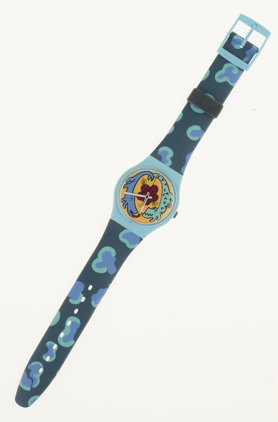 Front view of the Swatch 'Cayman' wrist watch showing the illustrated dial and patterned strap.