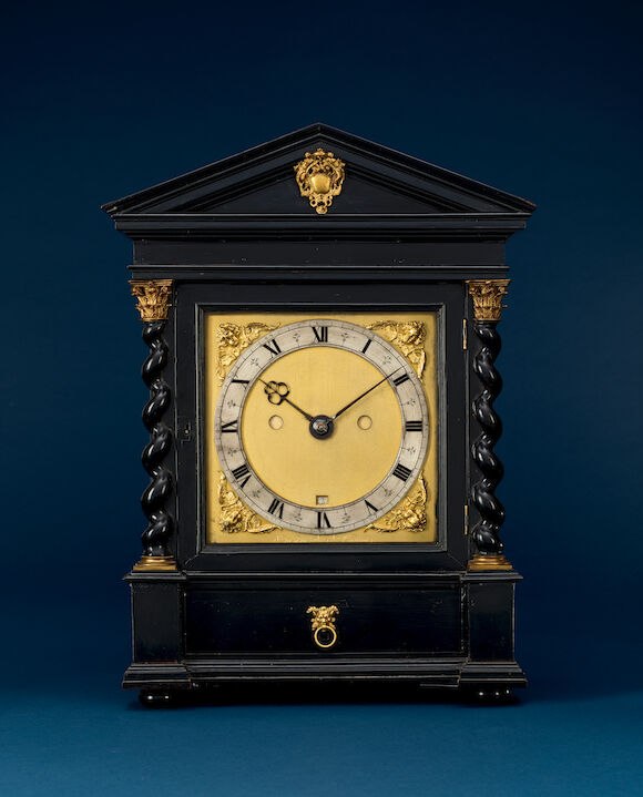 Front view of the architectural ebony table clock showing the pediment, twisted columns, and dial