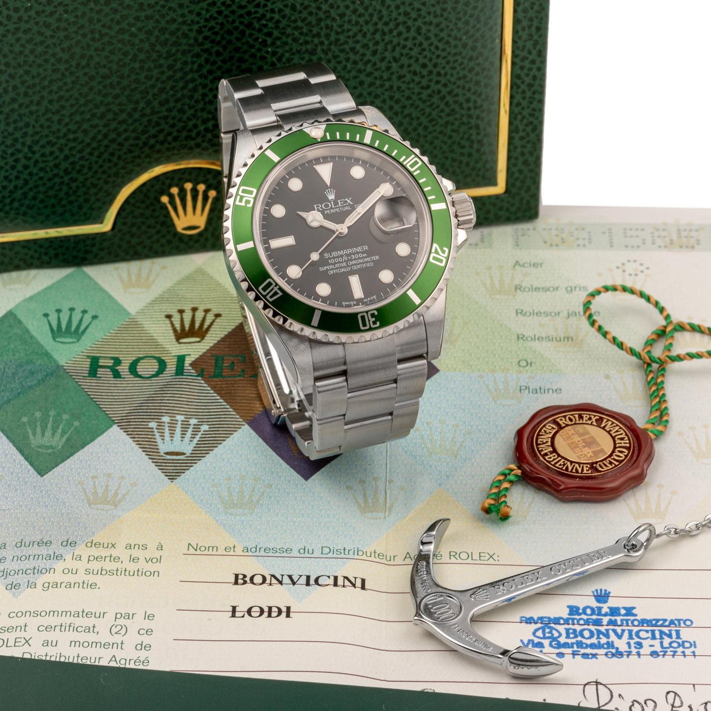 Rolex Submariner reference 16610LV, serial number F391565, complete with original box, warranty, anchor, and seal.