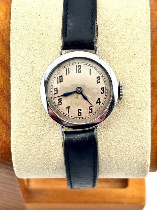Front view of the Swiss trench wristwatch on a display cushion
