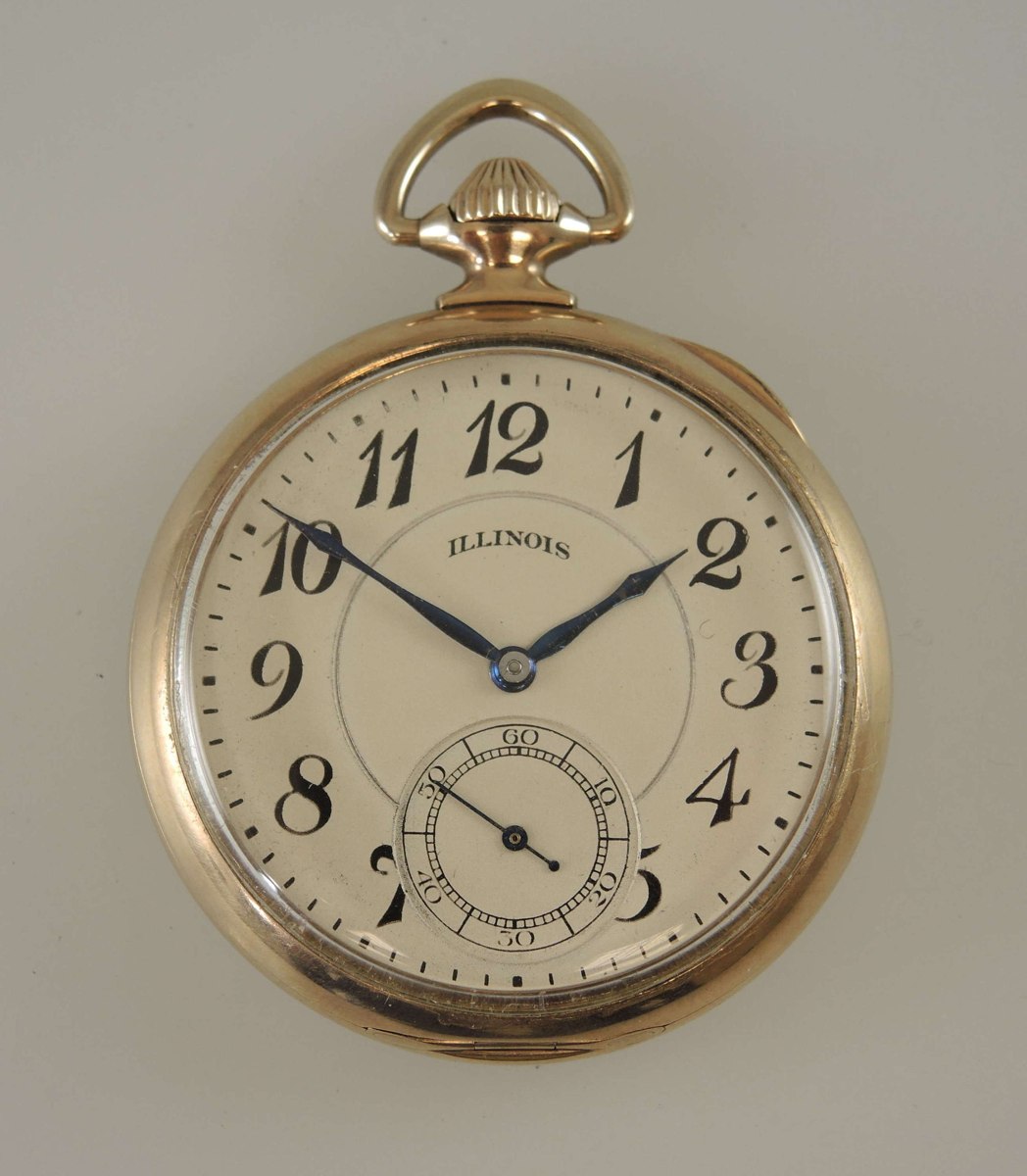 Front view of Illinois Sangamo Special pocket watch displaying the silvered Arabic dial and triangular bow