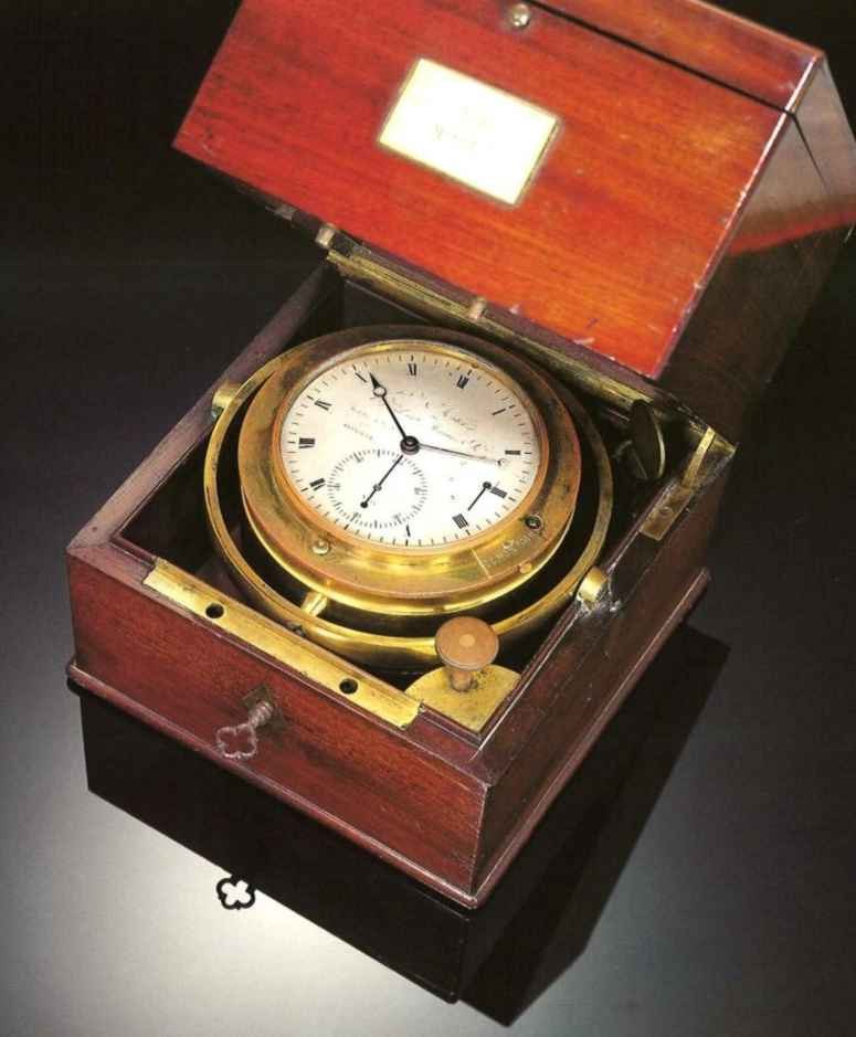 Top view of the Henri Motel marine chronometer in its mahogany box, showing the gimballed brass bowl and silvered dial.