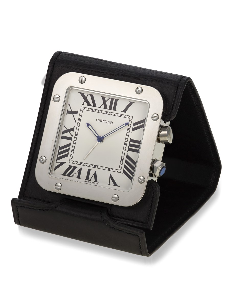 Three-quarter view of the Cartier Santos travel alarm clock ref. 2750 propped on its black leather folding stand