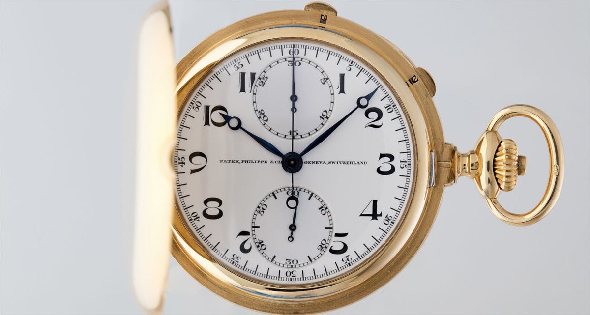 Dial and case front view of the Patek Philippe 18k yellow gold hunter-cased pocket watch with cover open
