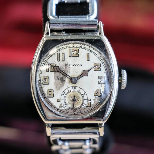 Bulova Spartan tonneau wristwatch with aged dial, sub-seconds dial, and metal link bracelet