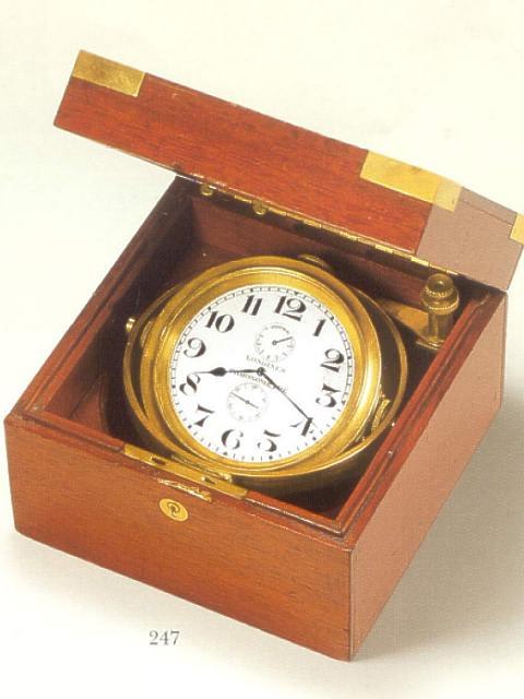 The Longines deck watch in its mahogany box with gimbal mounting, showing the silvered dial and up/down indicator.