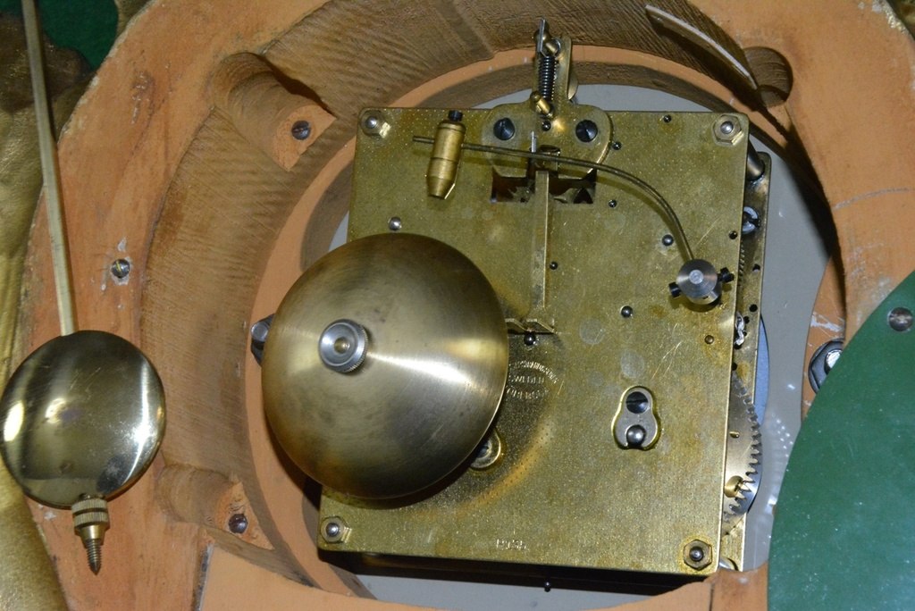 Rear interior view of the Westerstrand cartel clock showing the movement, bell, and pendulum