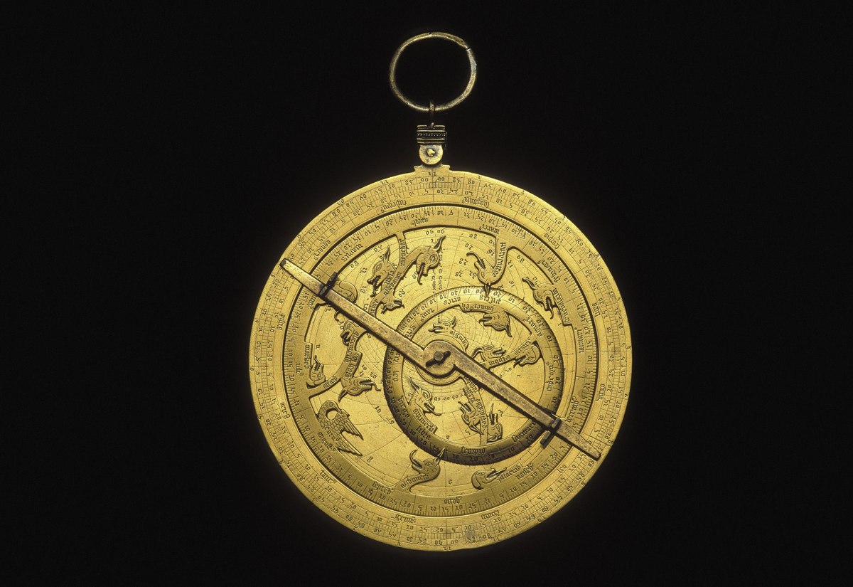 Front view of the English brass planispheric astrolabe displaying the zoomorphic rete, latitude plate, and suspension ring.