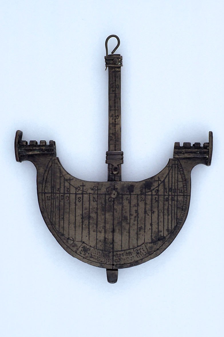The navicula dial viewed from the front, showing the central mast and ship-shaped body.