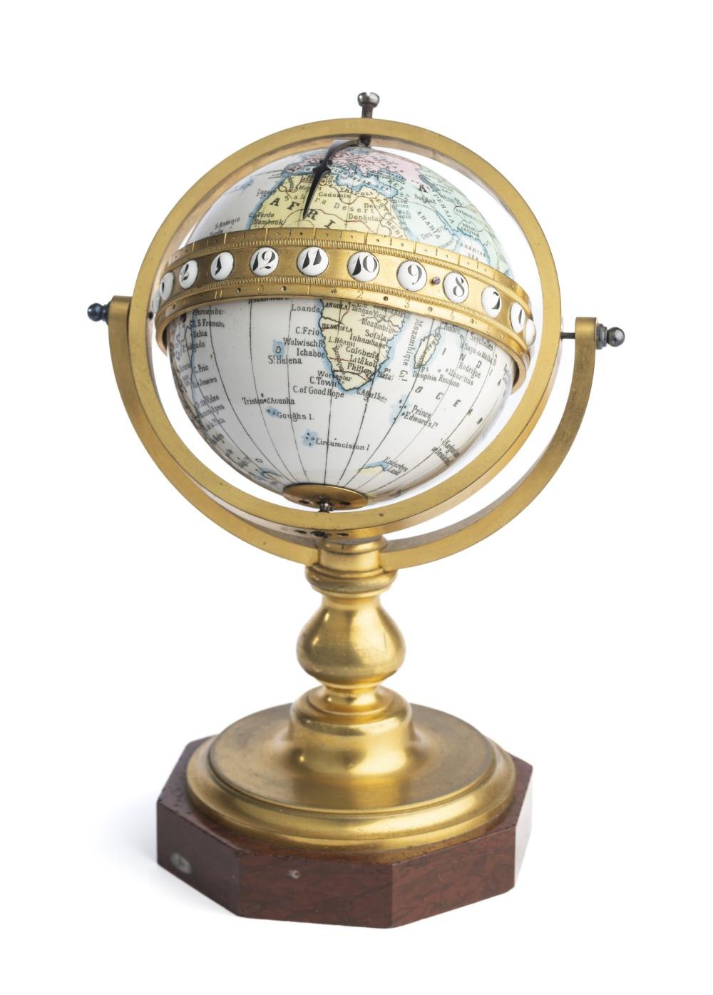 Full view of the Redier et Cie globe clock, showing the gilt-brass equatorial ring, the pointer, and the baluster-turned base.