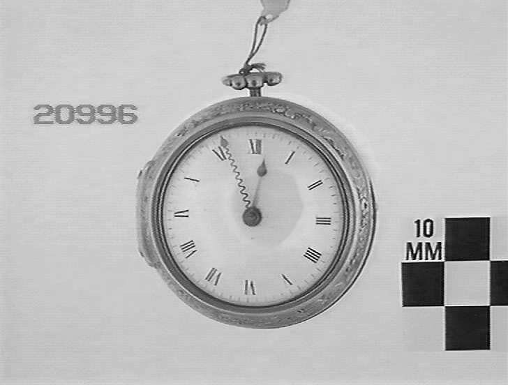 Front view of the gold pair case watch showing the enamel dial with Roman numerals.
