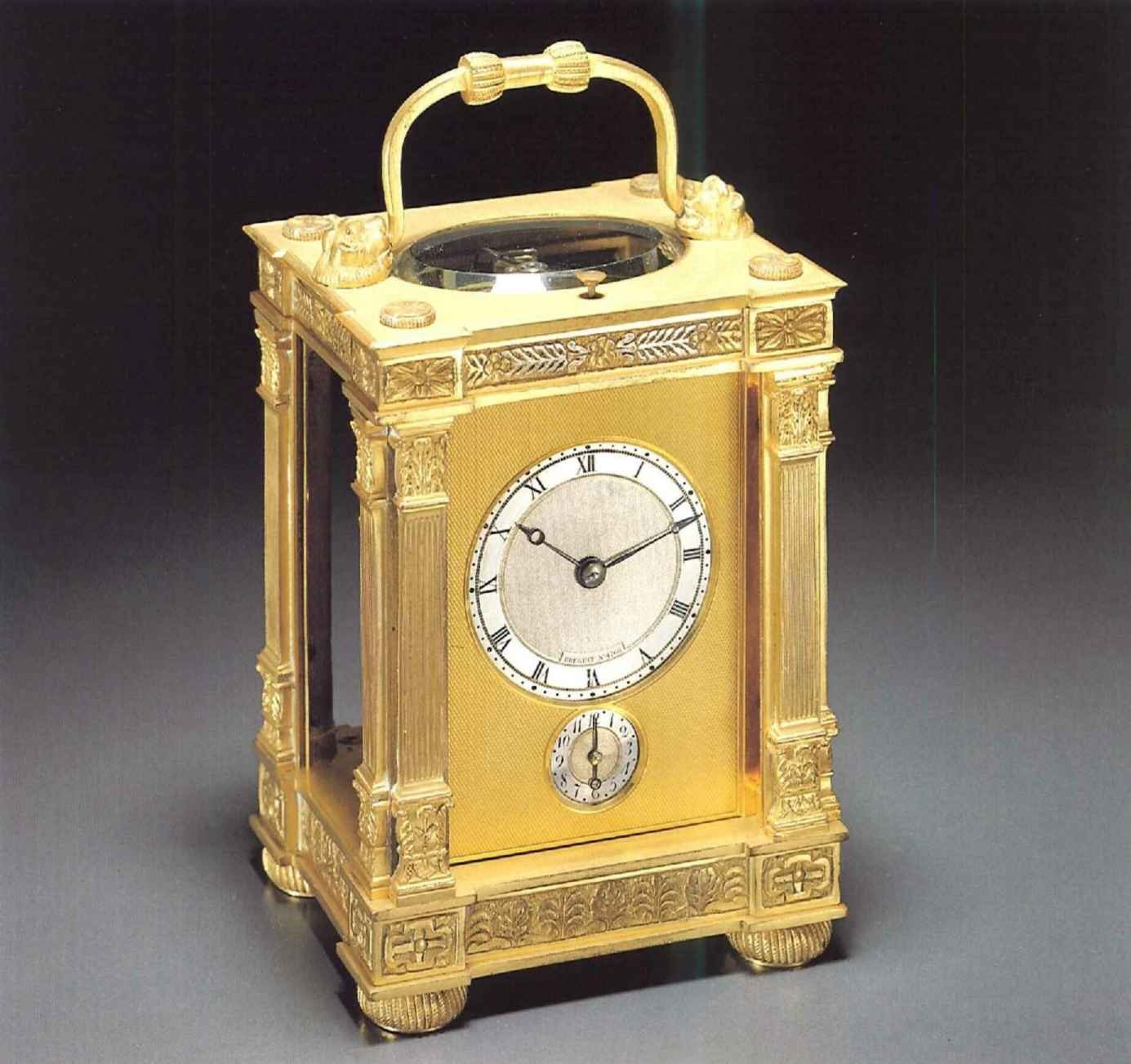 Gilt brass travelling clock, numbered 4768, featuring a silver dial and an alarm setting sub-dial.