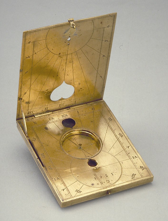 Gilt brass diptych dial by Christoph Schissler, 1566, showing the open leaves, internal string gnomon dials, and the compass compartment.