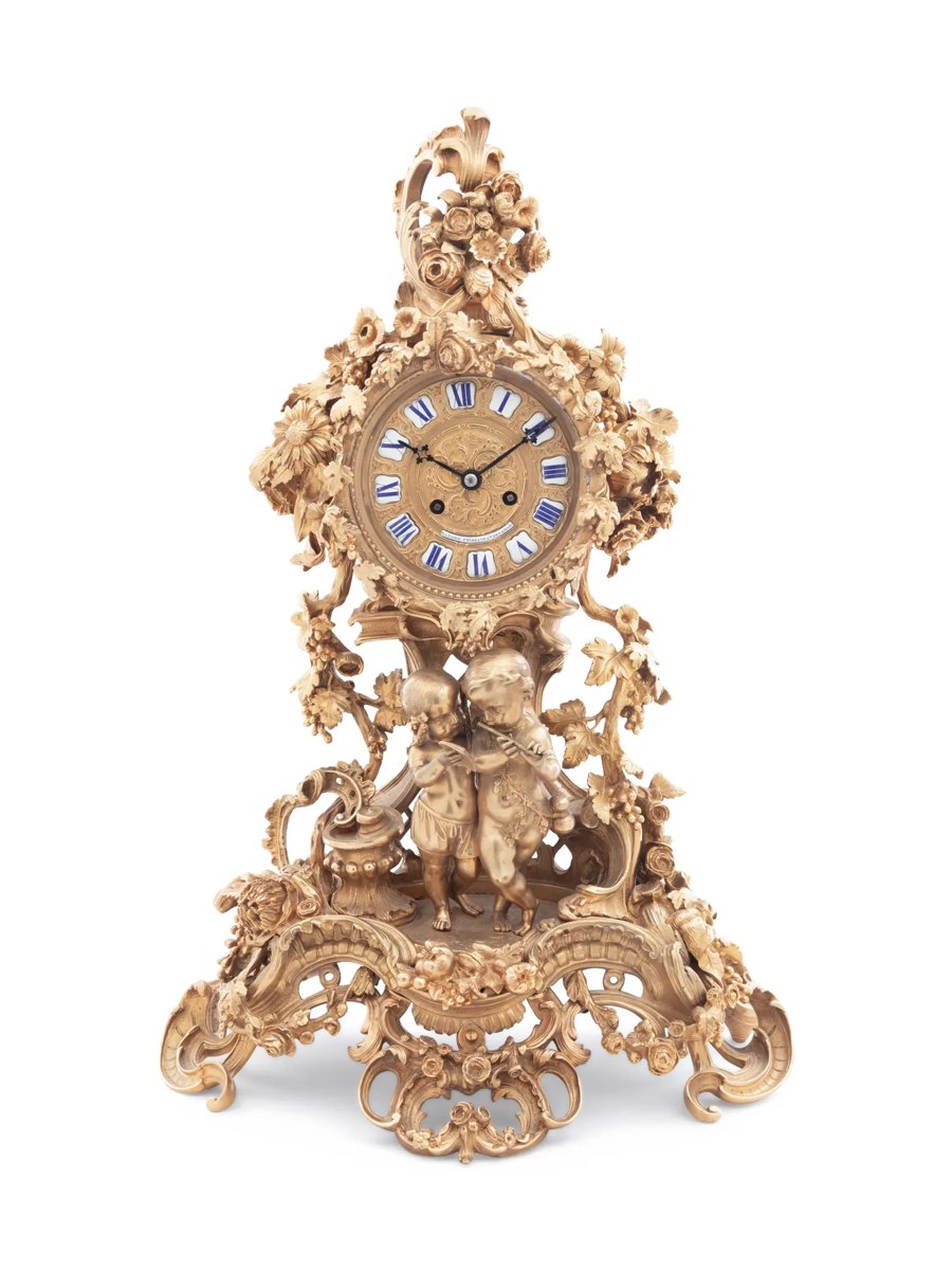Front view of the French gilt bronze mantel clock with figural putti group