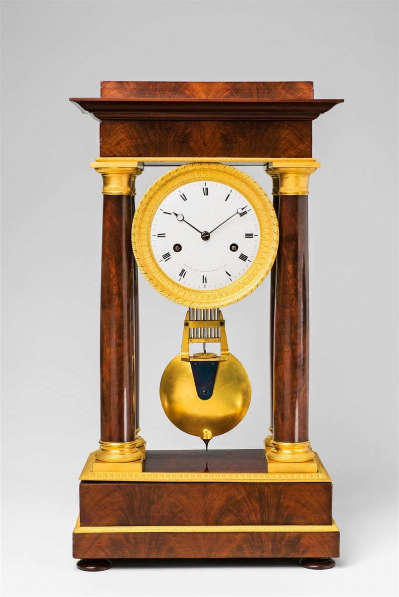 Front view of the portico regulator clock showing dial, columns, and gridiron pendulum