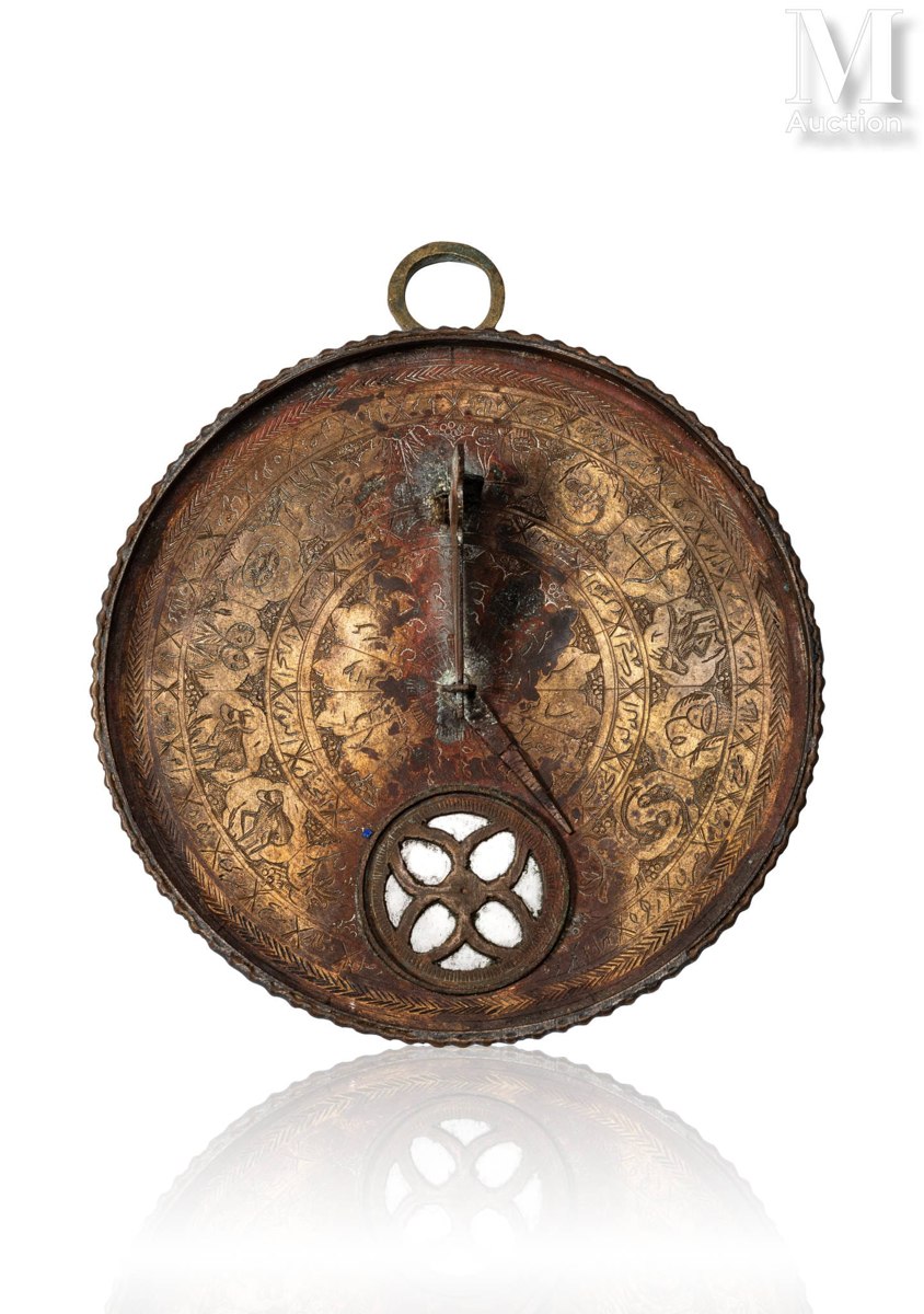 Front face of the engraved brass Qajar compass-sundial showing alidade, lower compass window, and suspension ring