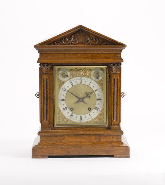 Front view of the oak-cased architectural quarter-striking table clock
