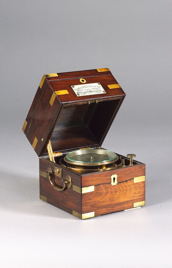 Oblique view of the two-day marine chronometer in an open brass-bound rosewood case