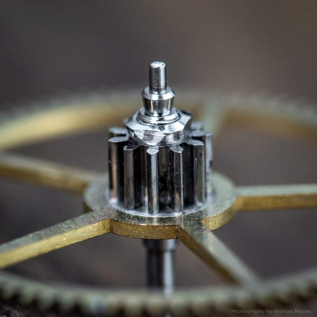 Macro photograph of assembled center wheel and Burt patent safety pinion with threaded nut installed