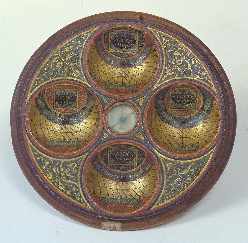 View of the interior of the scaphe dial, showing four hemispherical dial cavities, central compass, and decorative gold-leaf foliate work.