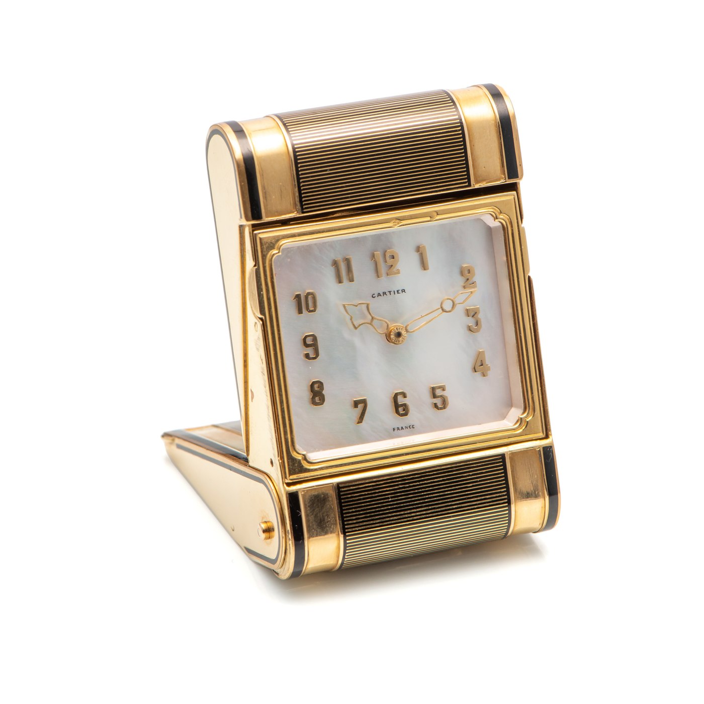 The 18k yellow gold and enamel Cartier travel clock in an open, upright position, displaying its mother-of-pearl dial.
